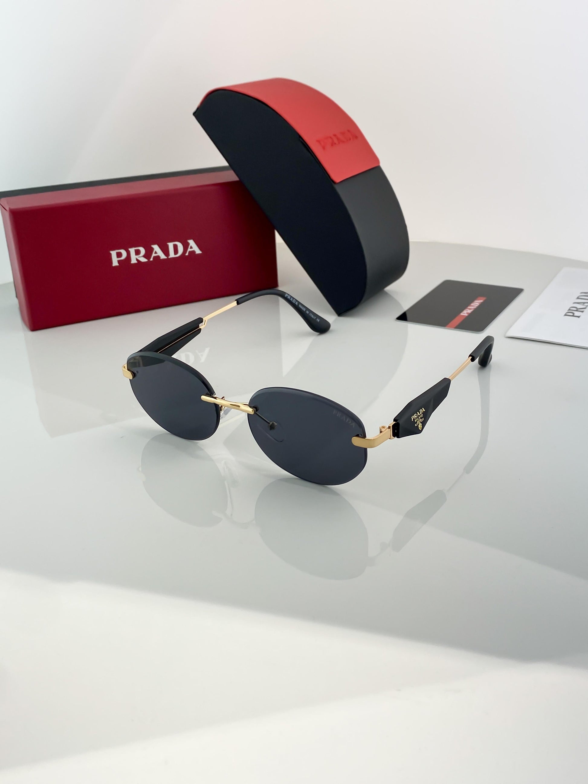 Prada gold black sunglasses with original box and kit