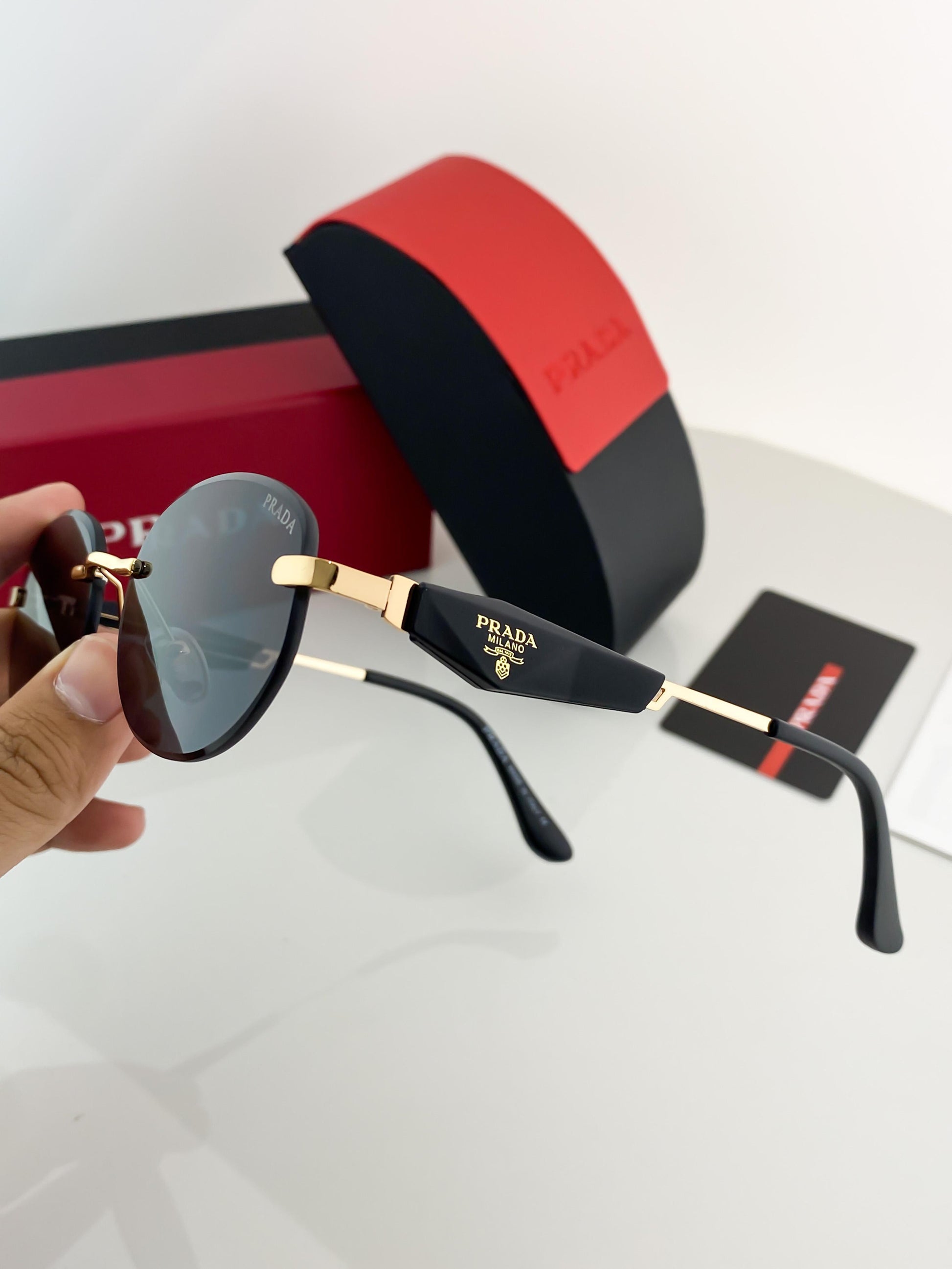 Prada gold black sunglasses with original box and kit