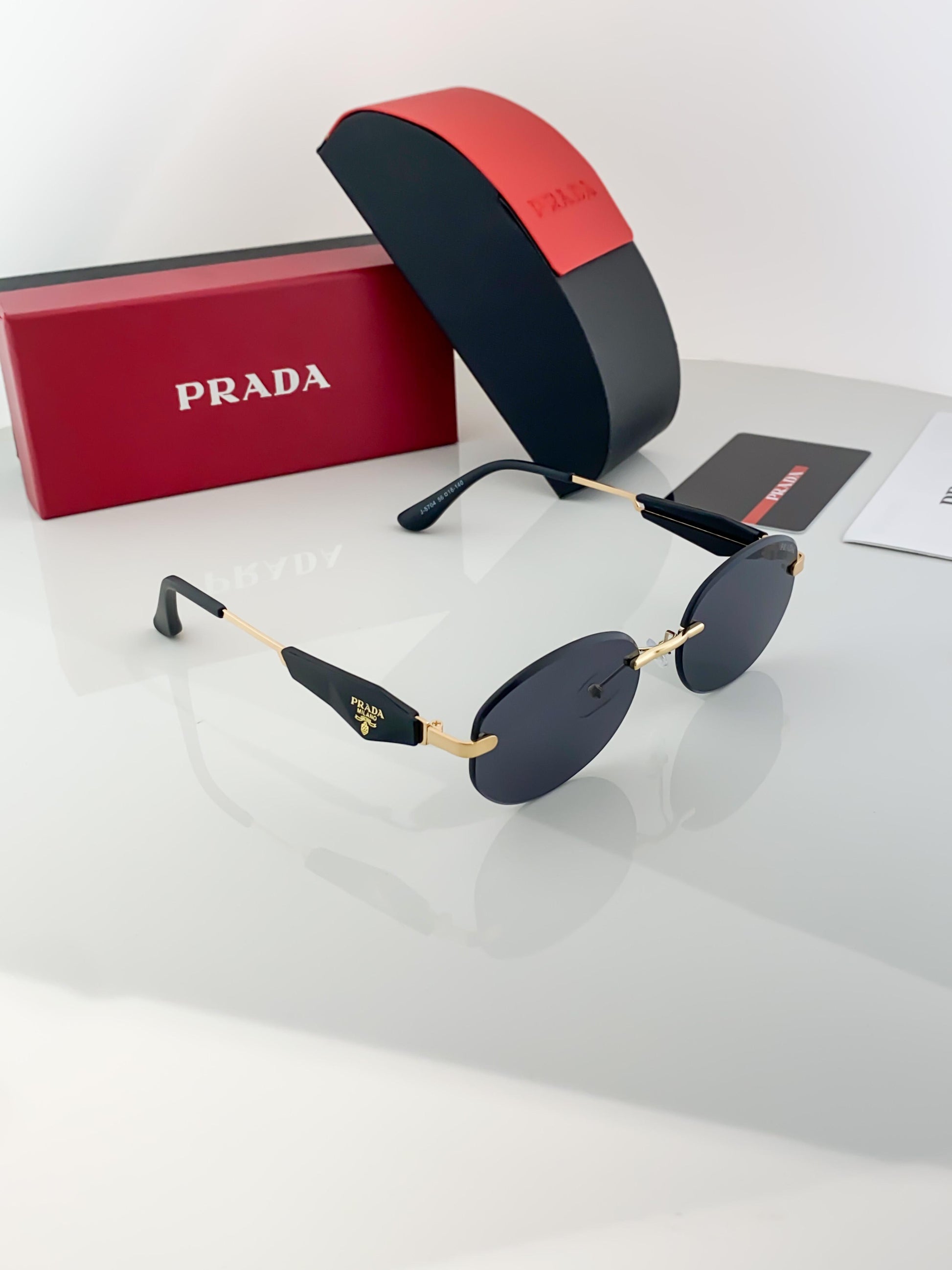 Prada gold black sunglasses with original box and kit
