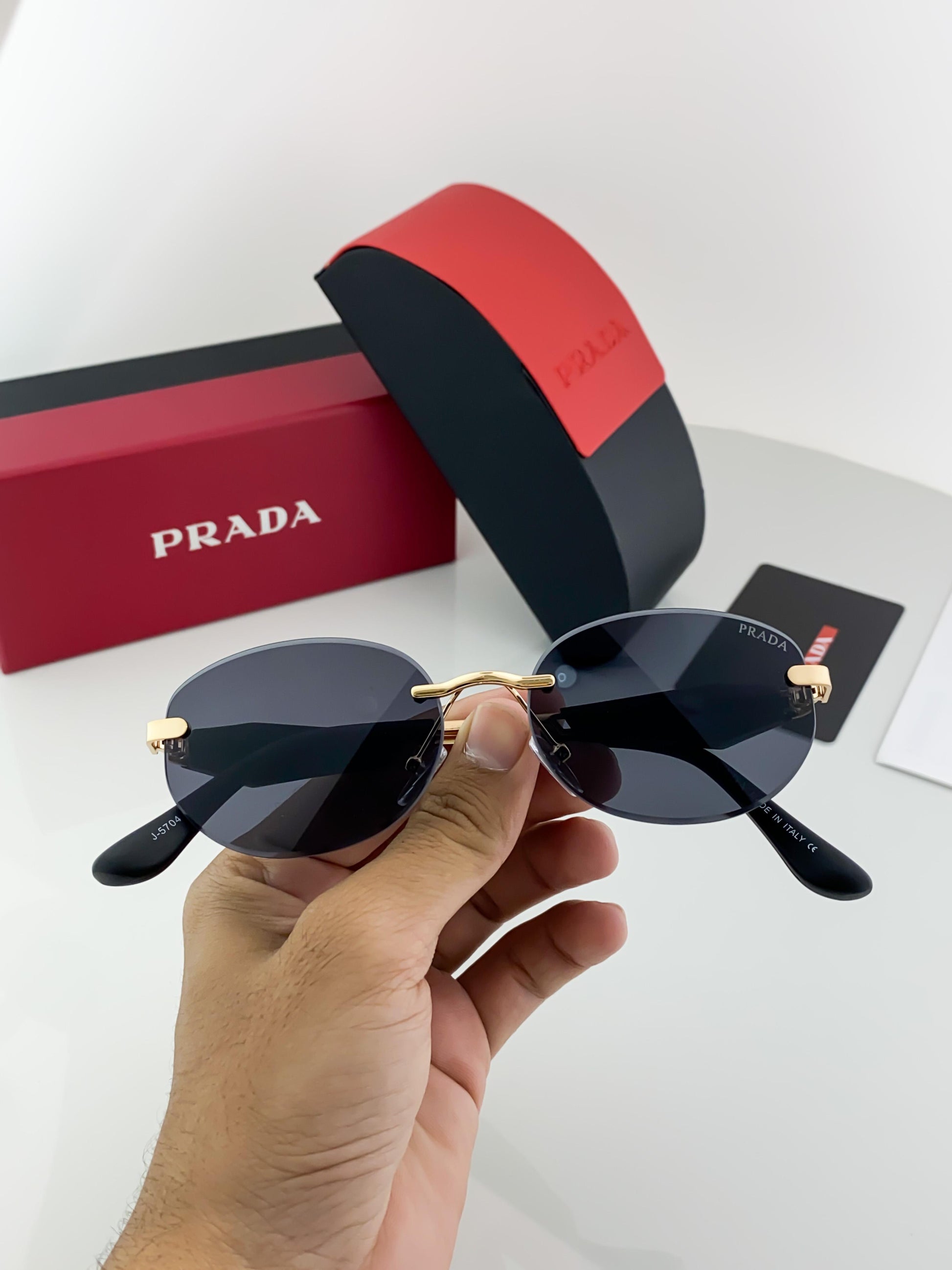 Prada gold black sunglasses with original box and kit