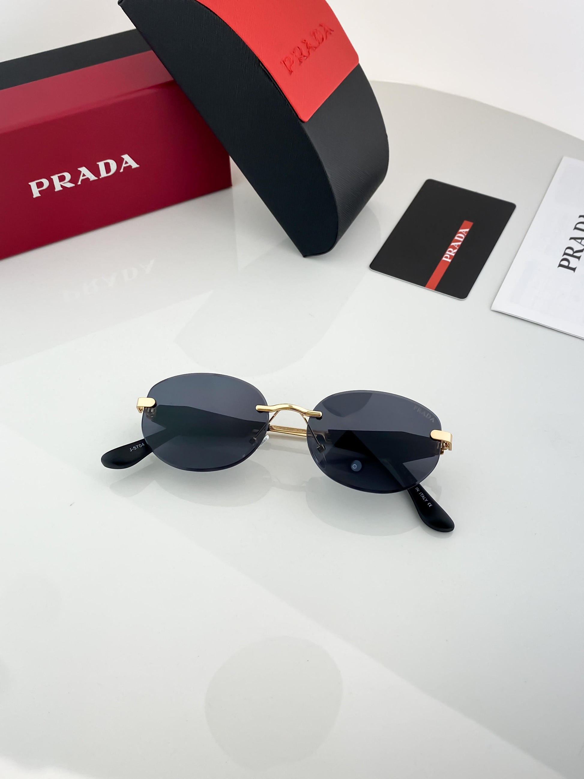 Prada gold black sunglasses with original box and kit
